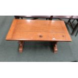 A rectangular oak coffee table, decorative cut ends with pegged central stretcher