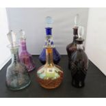 Six coloured cut glass decanters with stoppers