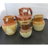 A glazed stoneware water jug impressed "GPO" and three others with applied topering scenes (4)