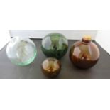 Three old glass fishing net floats and another with cork stopper