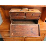 A small wood tool box, drop down front revealing two short and one longer narrow drawer and vacant