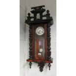 A late Victorian stained beech wall clock of regulator style, with carved decorative pediment A/F