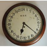 A 19th Century 24 hour wall clock in circular oak case, the white painted dial marked "KCC" with
