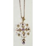 An early 20th Century 9ct gold pendant brooch of Art Nouveau form, set with amethysts and seed