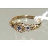 A 9ct gold ladies ring set with three sapphires in a Victorian style mount, ring size K+.