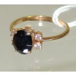 An 18ct gold ladies dress ring set with a central sapphire with two diamonds to either side, ring