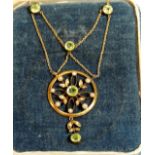 An early 20th Century, 9ct gold pendant and integral chain, set with peridots and seed pearls in