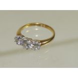 A ladies 18ct gold three stone diamond ring. The centre diamond half carat approx, with a smaller