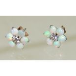 A pair of diamond and cabouchon opal pierced earrings, set in yellow and white metal and with