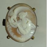 A Victorian gilt metal mounted shell cameo brooch. The cameo carved as a classical lady feeding an