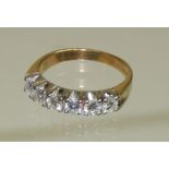 A ladies 18ct gold six stone diamond ring, claw set in openwork mount. Ring size P+