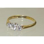 An 18ct gold three stone diamond ring, the centre stone quarter carat approx and set in an