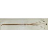 A 9ct gold, retractable swizel stick, the case with bark effect decoration. 5.2g approx.