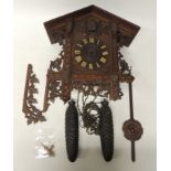 A Victorian Black Forest Cuckoo Clock in typical chalet style case having marquetry decoration,