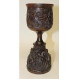 A Russian wooden wine goblet, turned and hand carved with foliate design, 20cms high