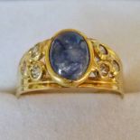 RING SET WITH A CABOCHON SAPPHIRE AND OTHER GEMS, THE SETTING MARKED 750