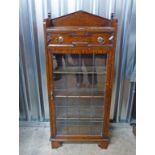 20TH CENTURY OAK BOOKCASE OF DRAWER OVER LEADED GRASS PANEL DOOR