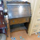 EARLY 20TH CENTURY OAK STUDENTS BUREAU WITH FALL FRONT OVER DRAWER OVER OPEN SHELF 104CM TALL