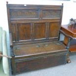 OAK SETTLE WITH DECORATIVELY CARVED PANEL BACK ABOVE 2 HINGED BOX SEATS WITH 17TH CENTURY