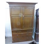 20TH CENTURY OAK LINEN PRESS OF 2 PANEL DOORS OVER 2 SHORT & 2 LONG DRAWERS ON PLINTH BASE.