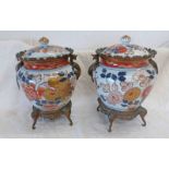 PAIR OF IMARI STYLE ORMOLU MOUNTED JARS AND COVERS HEIGHT 29CMS ON BRASS ELEPHANT TRUNK SUPPORTS