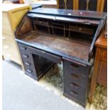 20TH CENTURY MAHOGANY ROLL TOP DESK OF 9 DRAWERS ON PLINTH BASE