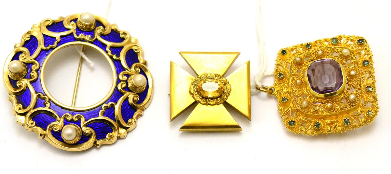 # Three Victorian brooches; the first a hoop enamelled in blue, with scroll decoration, and four