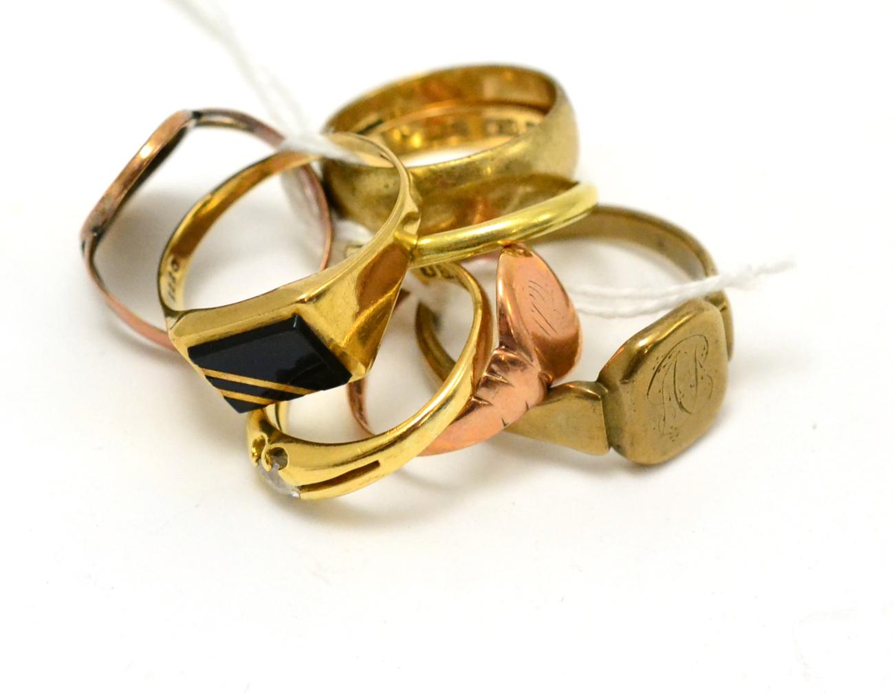 A group of rings including a 9ct gold band ring, four gents 9ct gold rings, an 18ct gold band