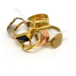 A group of rings including a 9ct gold band ring, four gents 9ct gold rings, an 18ct gold band