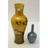 A Chinese mustard glazed baluster vase decorated with dragons and a small Chinese bottle vase