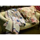 Circa 1930's striped reversible quilt in cream and floral printed cottons, 260cm by 215cm; an