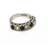 An 18ct white gold sapphire and diamond half hoop ring