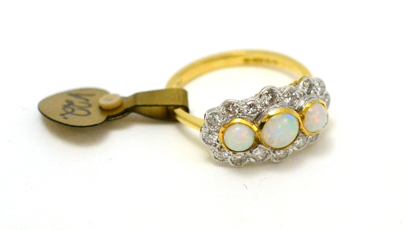 An 18ct gold opal and diamond triple cluster ring