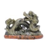 A Chinese soapstone figure of a dragon, on stand