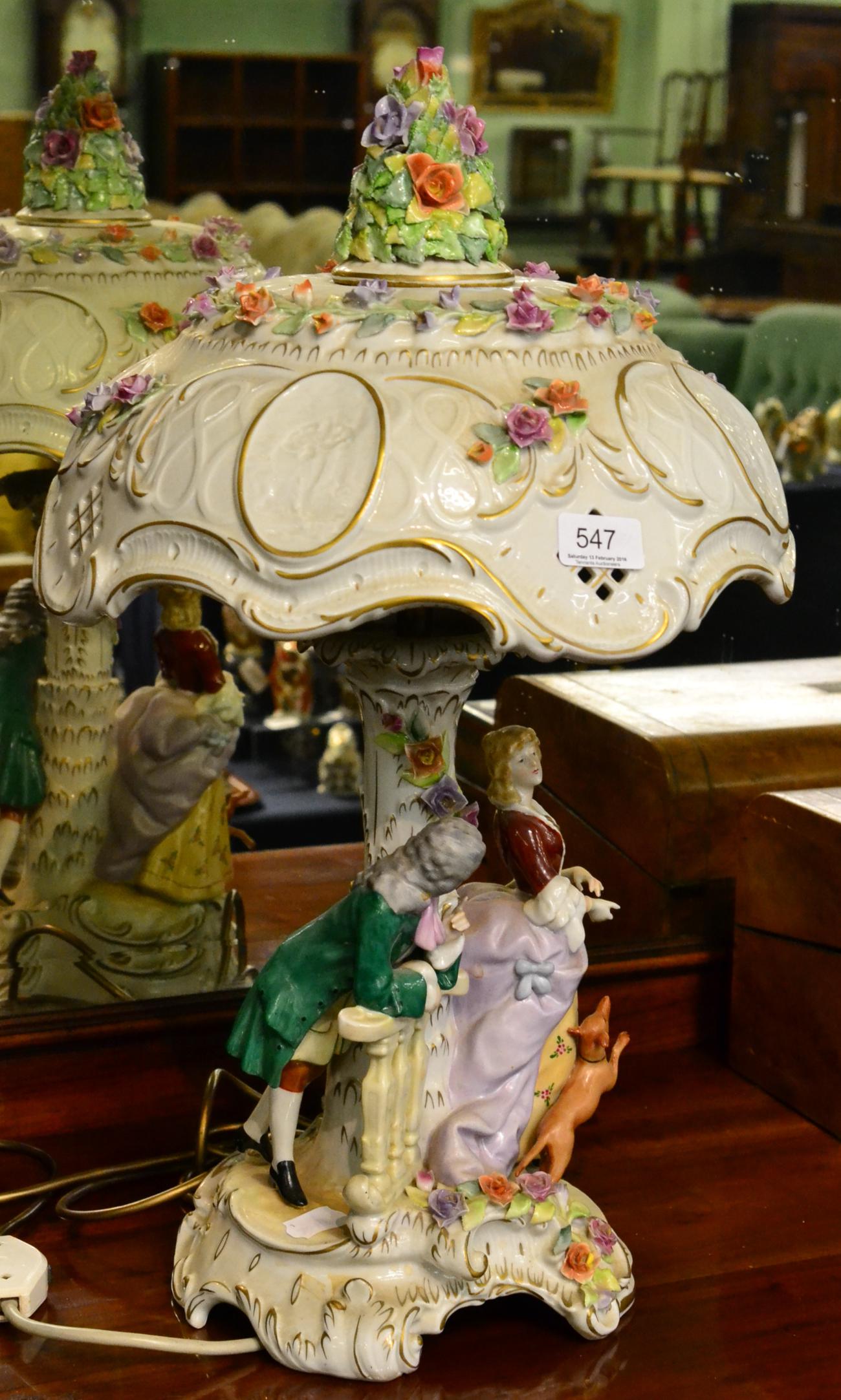 A Continental flower encrusted figural lamp and shade