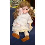 A German Ernst Heubach bisque socket head character doll, impressed '267.9', with brown wig worn