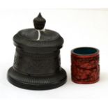 A turned snuff box and a Chinese cinnabar lacquer brush pot