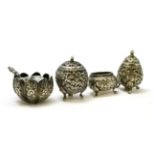 A 19th century Burmese silver cruet set; consisting of two pepperettes and two salts, together