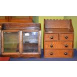 A doll's early 20th century oak chest of drawers and small glazed cabinet