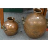 A large twin-handled copper vessel together with a smaller example (2)
