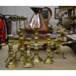 A copper warming stand and jug, six pairs of candlesticks, fire dogs and irons etc