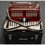 A Stephanelli Piano Accordion, with red pearl body, in a fitted case
