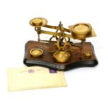 Postal Scales brass scales on wooden base with one pan engraved with postal rates up to 12oz, 4d;