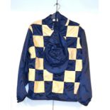 A Set of Racing Silks, comprising a blue and white checked jacket and a blue cap, made by Frost