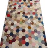 Cotton Printed Hexagonal Patchwork Quilt, with cream reverse, signed Nellie McKendry, 190cm by 140cm