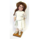 A French Jumeau Bisque Socket Head Child Doll, impressed '10' and stamped in blue 'Tete Jumeau',