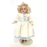 A German Kammer & Reinhardt Bisque Socket Head Walking Doll, with original blond wig, sleeping