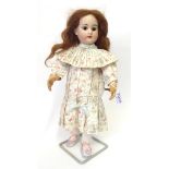 A French Roullet et Decamps Bisque Socket Head Walking Doll, with original brown wig, fixed brown