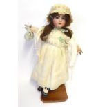 A French Jumeau Bisque Socket Head Child Doll, impressed '1907' '9', with brown wig, pierced ears,