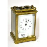 A brass carriage clock and key